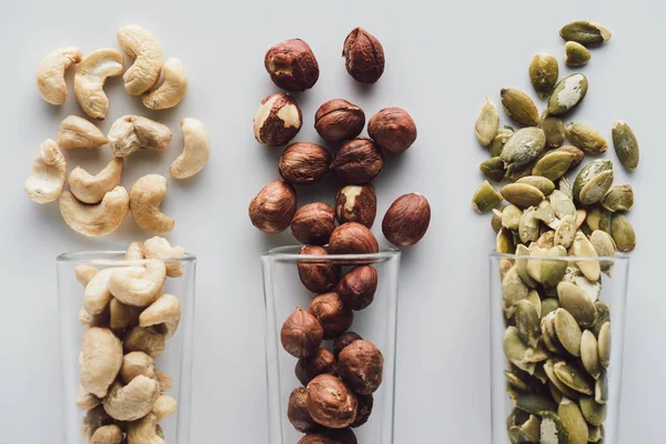 Variety of nuts in glass cups isolated on white background — Stock Photo