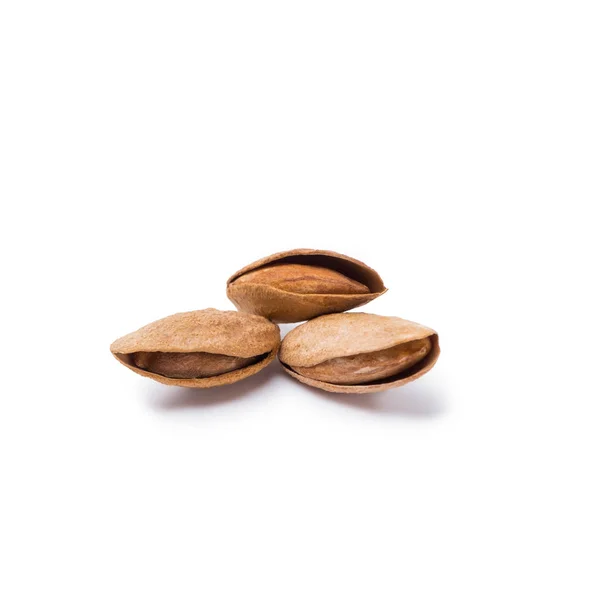 Handful of almonds in nutshells isolated on white background — Stock Photo