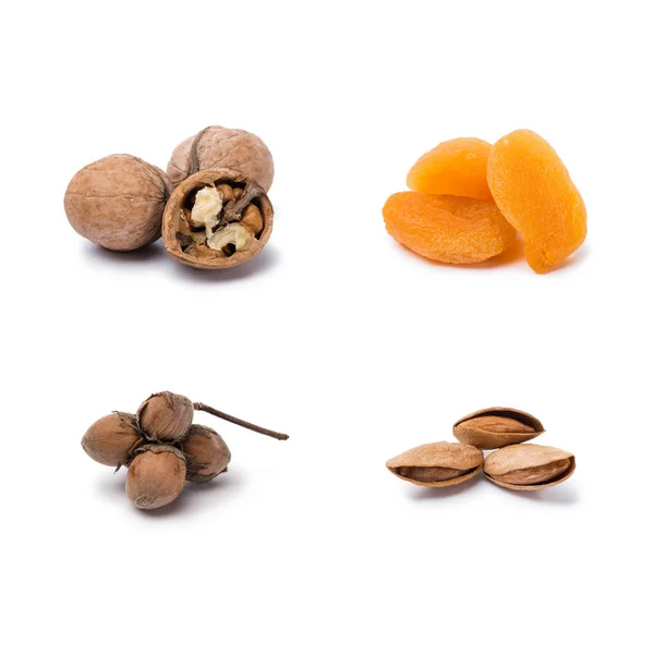 Handfuls of assorted nuts and dried apricots isolated on white background — Stock Photo