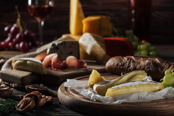 Brie cheese on cutting board in kitchen — Stock Photo