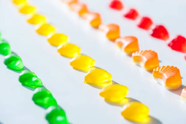 Serie di caramelle di gelatina dolci verdi, gialle e rosse su bianco — Foto stock