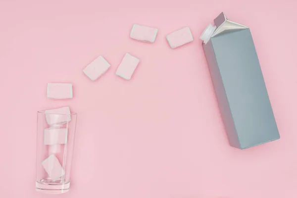 Top view of yummy marshmallows, glass and carton package isolated on pink — Stock Photo