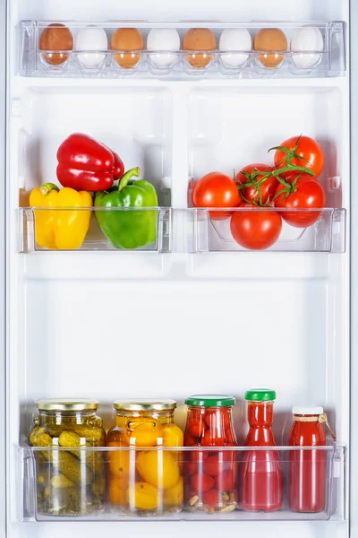 Tasty ripe and preserved vegetables in fridge — Stock Photo