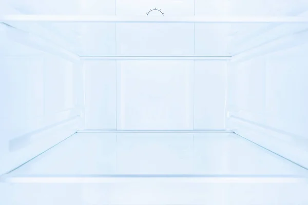 Shelves in empty open white fridge — Stock Photo