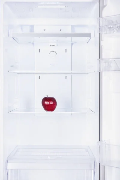 One ripe red apple in fridge — Stock Photo