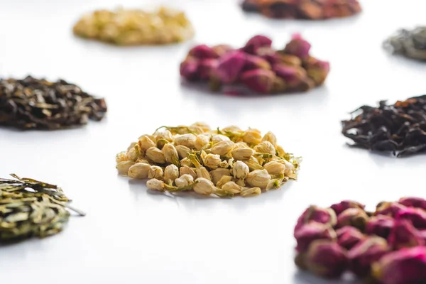 Pattern of organic herbal dried tea on white tabletop — Stock Photo