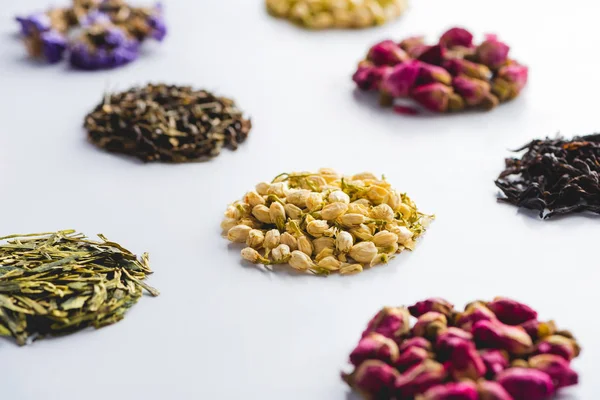 Collection of dried herbal healthy tea on white surface — Stock Photo