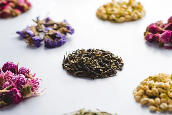 Pattern of dried herbal organic tea on white surface — Stock Photo