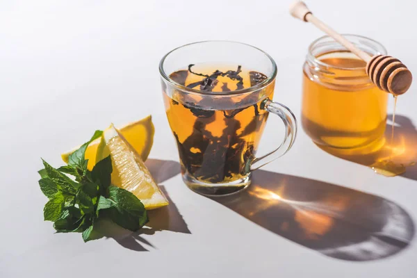 Thé sain au citron et à la menthe sur une table blanche — Photo de stock