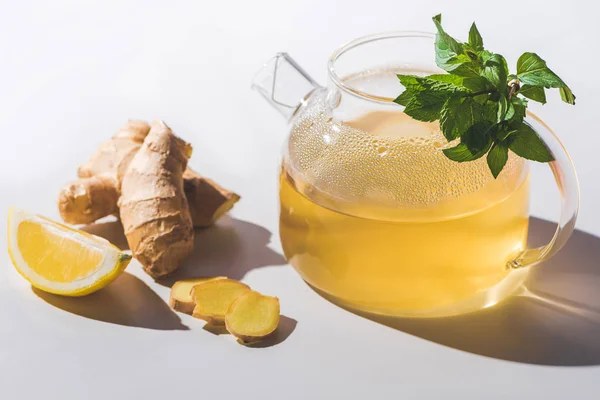 Healthy tea with lemon and mint on white tabletop — Stock Photo