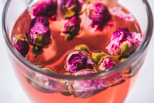 Close up of tea with dried rose buds — Stock Photo