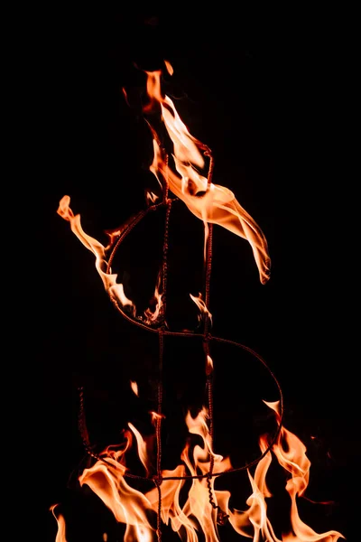 Close up view of burning dollar sign isolated on black — Stock Photo