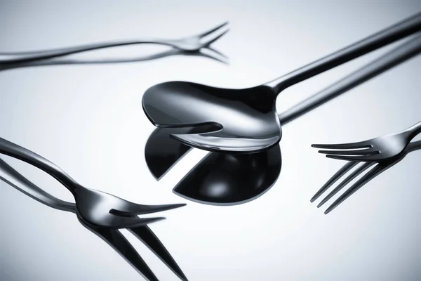 Close-up view of shiny stainless steel cutlery reflected on grey — Stock Photo