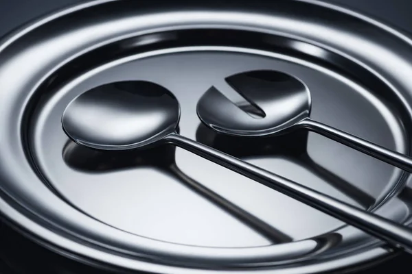 Close-up view of shiny ladles on metal tray on grey — Stock Photo