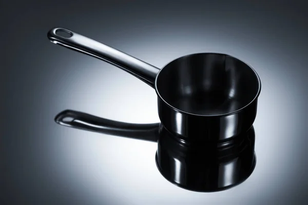 Close-up view of stainless steel pot with reflection on grey — Stock Photo