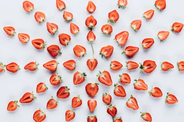 Top view of star composition made of halved strawberries on white surface — Stock Photo