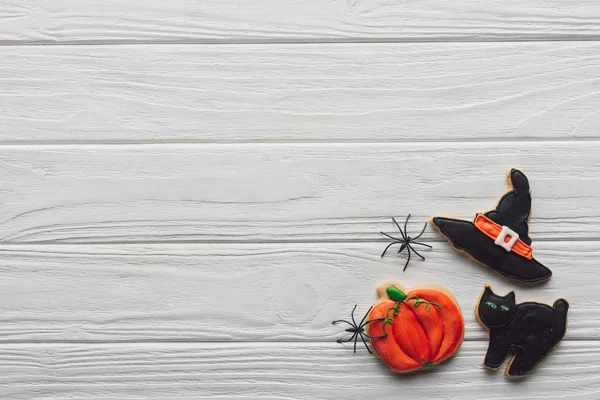 Elevated view of tasty homemade halloween cookies on wooden background — Stock Photo