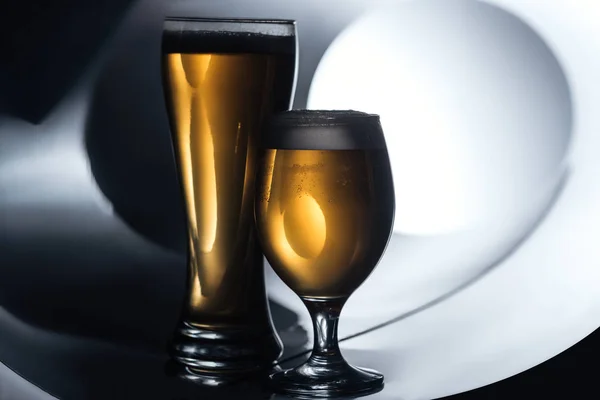 Beer in glasses on white and black background, oktoberfest concept — Stock Photo