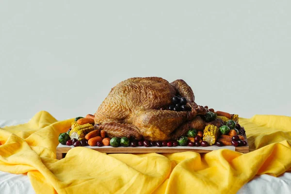 Close up view of holiday dinner table set with roasted turkey and vegetables on grey background, thanksgiving holiday concept — Stock Photo