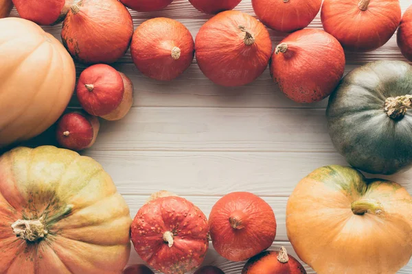 Top view of ripe organic pumpkins on wooden tabletop — Stock Photo