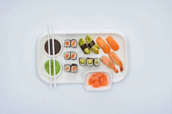 Top view of gourmet sushi set with chopsticks isolated on white — Stock Photo