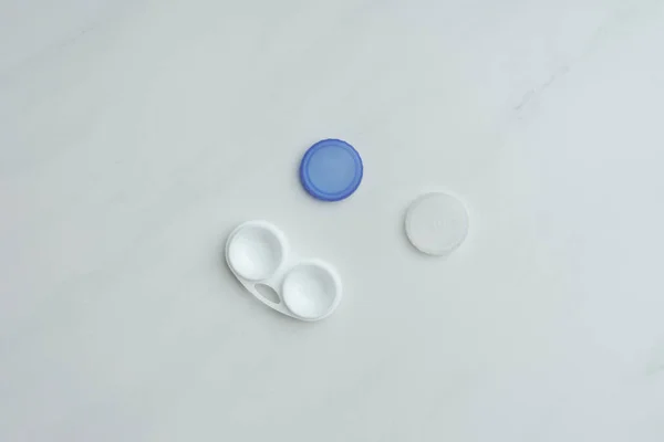 Top view of contact lenses container on white tabletop — Stock Photo