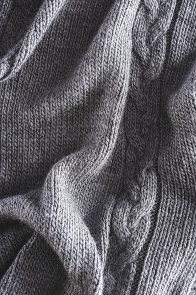 Plein cadre de tissu tricoté gris plié comme toile de fond — Photo de stock