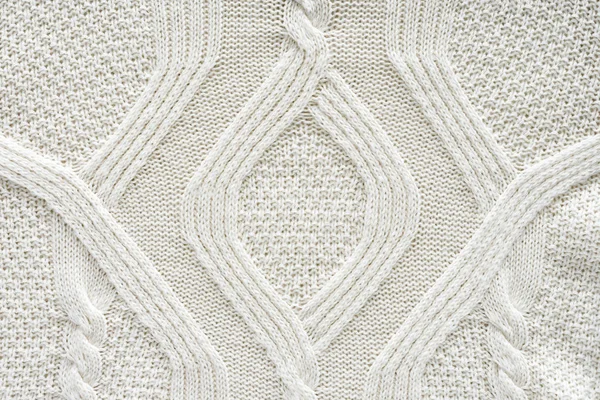 Plein cadre de tissu tricoté blanc avec motif comme fond — Photo de stock