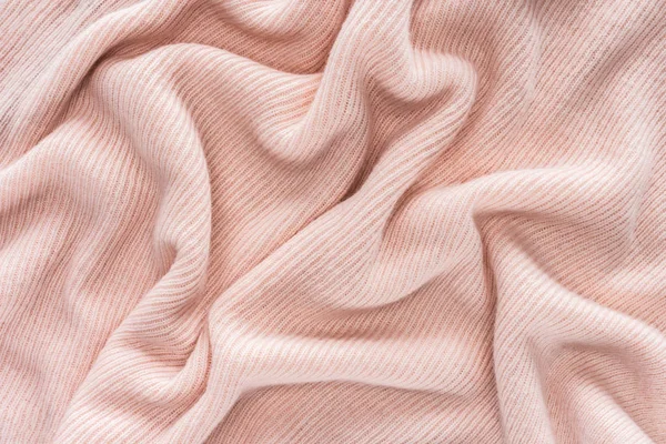 Full frame of pink folded woolen fabric background — Stock Photo