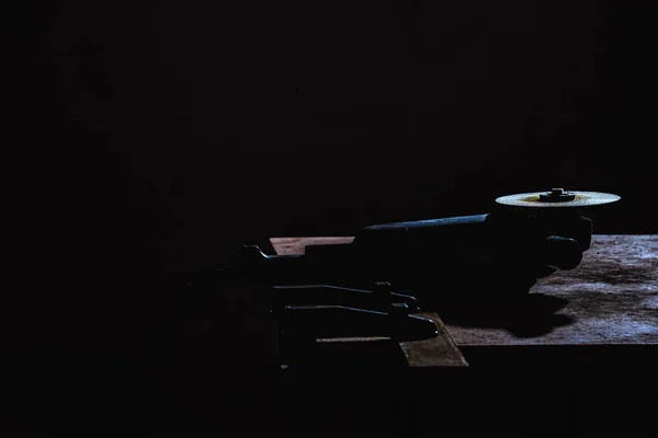 Selective focus of circular saw in dark at factory — Stock Photo