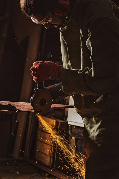 Travailleur masculin concentré dans les lunettes de protection travaillant avec une scie circulaire à l'usine — Photo de stock