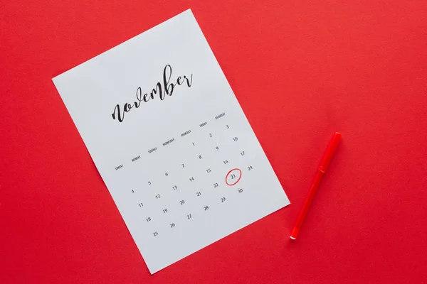 Top view of calendar for November with marker isolated on red, black friday concept — Stock Photo