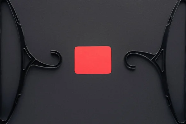 Top view of hangers and empty red card for black friday — Stock Photo