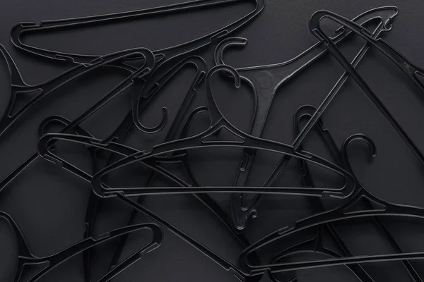 Background with black hangers on black, top view for black friday — Stock Photo