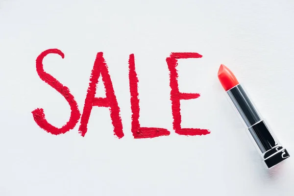 Sale sign and red lipstick on white, special offer for black friday — Stock Photo