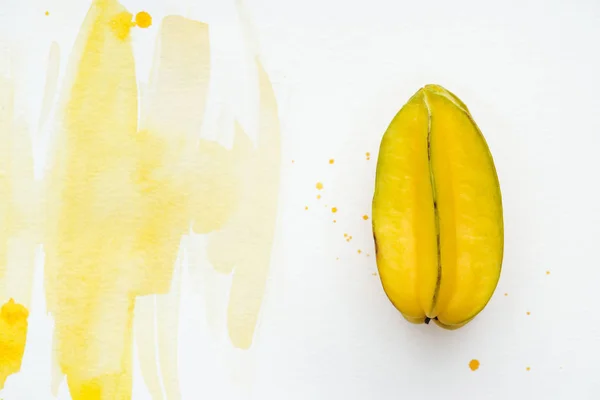 Top view of tasty exotic carambola on white surface with yellow watercolor — Stock Photo