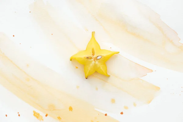 Vista superior da deliciosa carambola exótica na superfície branca com aquarela amarela — Fotografia de Stock
