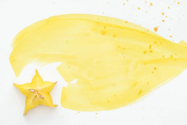 Top view of sweet carambola on white surface with yellow watercolor — Stock Photo