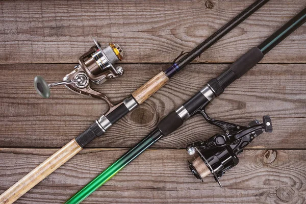 Top view of fishing rods on wooden background, minimalistic concept — Stock Photo