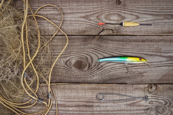 View from above of fishing float, bait and fishing net on wooden planks — Stock Photo