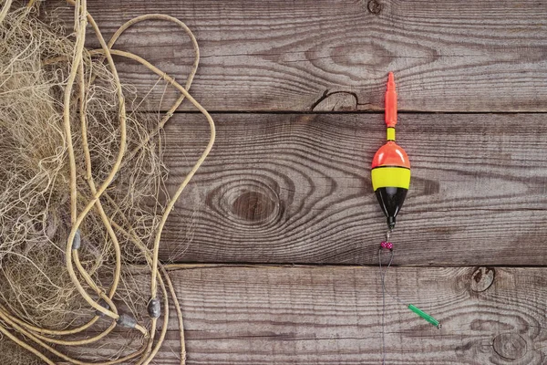 Top view of fishing float and fishing net on wooden background — Stock Photo