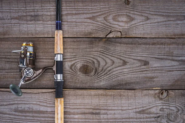 View from above of fishing rod on wooden planks, minimalistic concept — Stock Photo