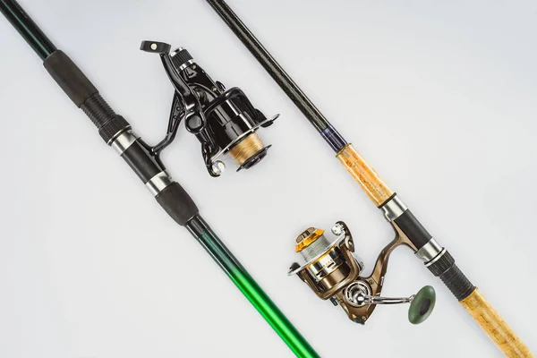 Flat lay with arranged fishing rods isolated on white, minimalistic concept — Stock Photo