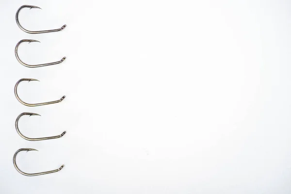 Top view of fishing hooks placed in row isolated on white — Stock Photo