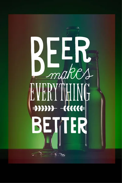 Bottles and glass of beer on dark green background with 