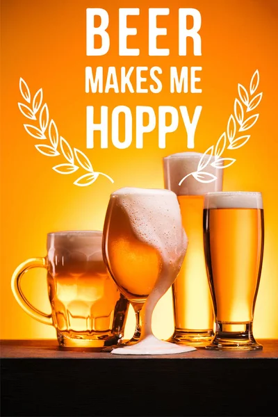 Arranged mugs of cold beer with froth on orange background with 