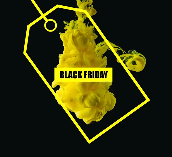 Bright yellow flowing ink on black background with sale tag for black friday — Stock Photo