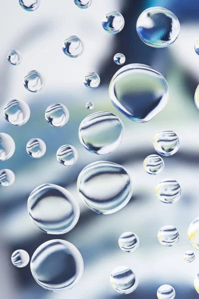 Beautiful transparent water drops on light blurred background — Stock Photo