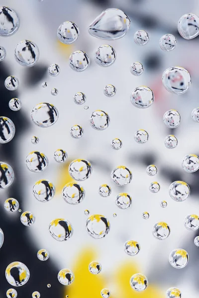 Close-up view of beautiful clean dew drops on blurred abstract background — Stock Photo