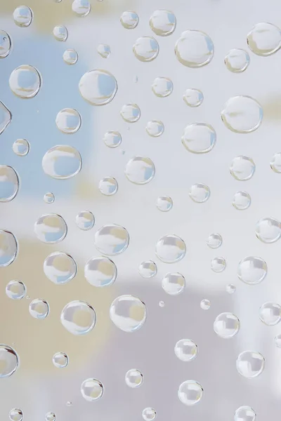 Beautiful transparent drops on blurred abstract background — Stock Photo